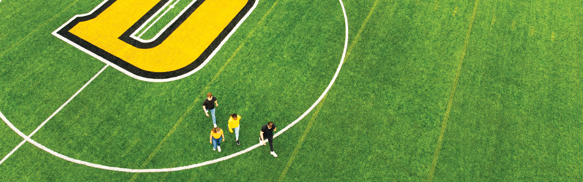 Students walk across Wickwire Field